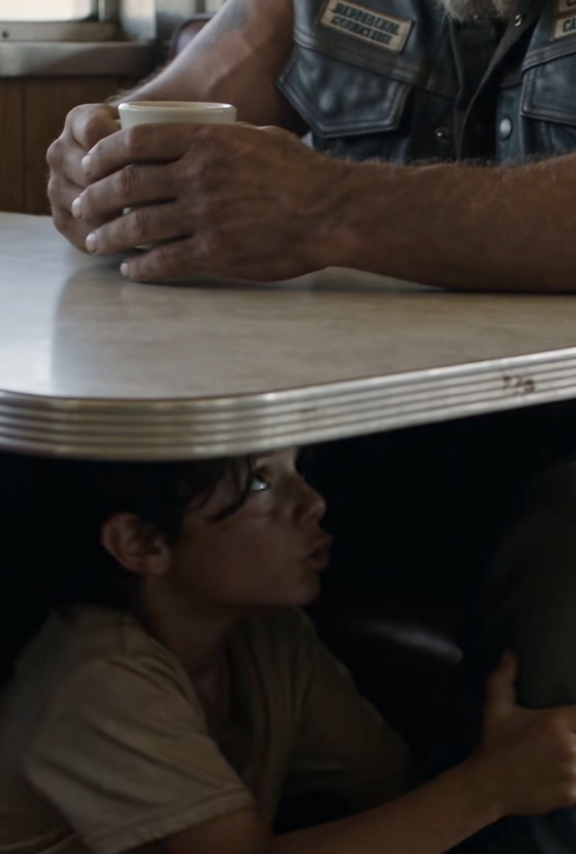 The Little Boy Hid Under an Outlaw Biker’s Table — Then the Police Officer Walked In